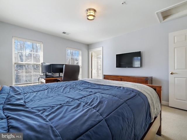 carpeted bedroom featuring visible vents, attic access, and baseboards