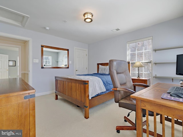 bedroom featuring attic access, light colored carpet, visible vents, and baseboards