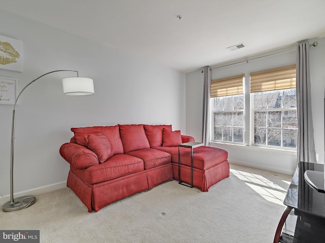 living room featuring carpet, visible vents, and baseboards