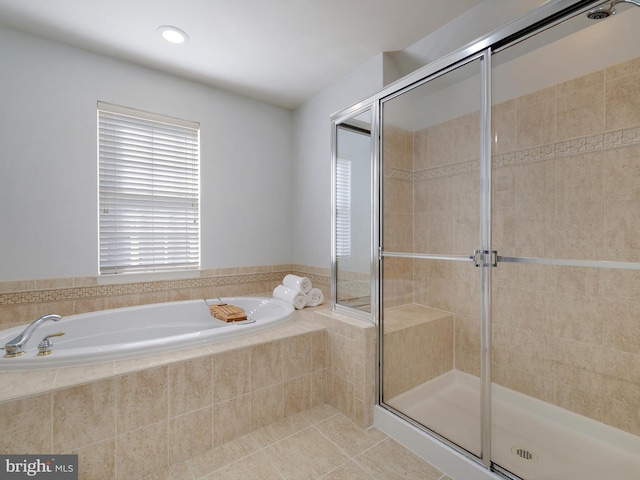 full bath with a shower stall, a bath, and tile patterned floors