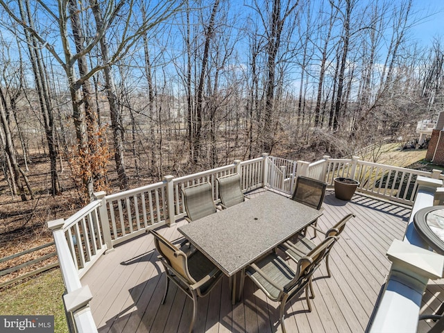 wooden terrace with outdoor dining area