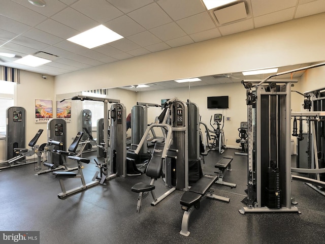 exercise room with a paneled ceiling and visible vents