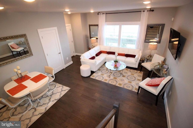 living room with baseboards, wood finished floors, and recessed lighting