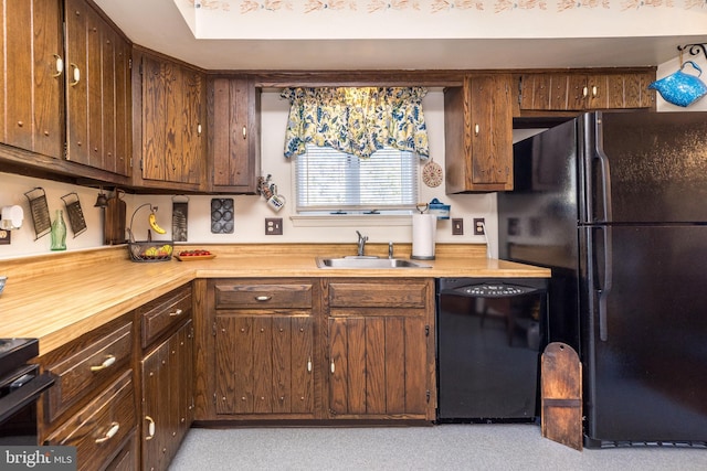 kitchen with black appliances and a sink