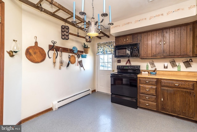 kitchen with baseboards, light countertops, baseboard heating, a notable chandelier, and black appliances