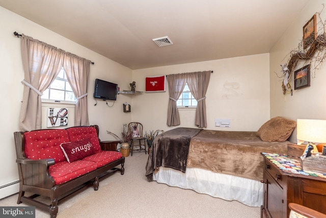 bedroom featuring visible vents, baseboard heating, and carpet flooring