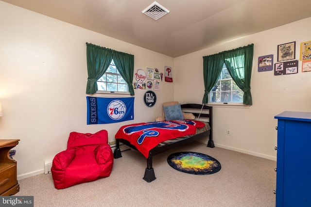 bedroom featuring visible vents, baseboards, and carpet flooring