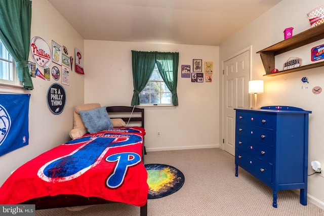 bedroom featuring baseboards and carpet flooring