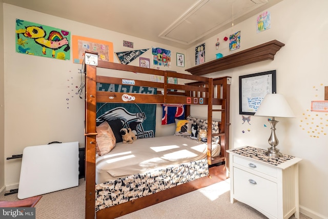 bedroom with attic access and carpet floors