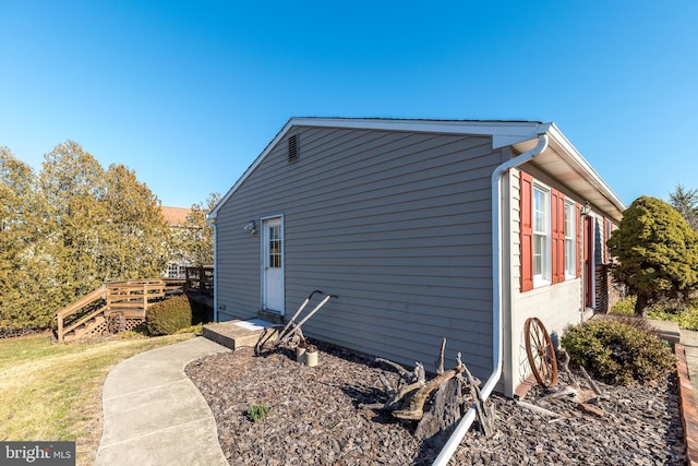 view of side of home with a wooden deck