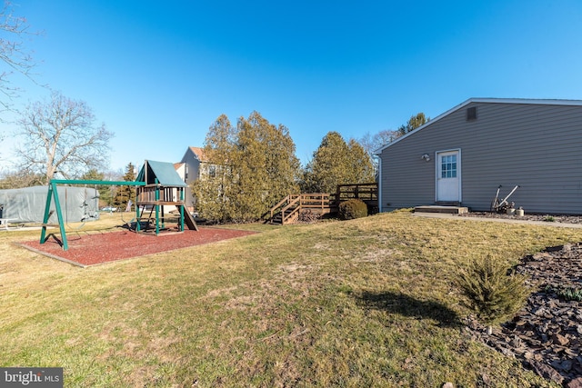 view of yard with a playground and a wooden deck