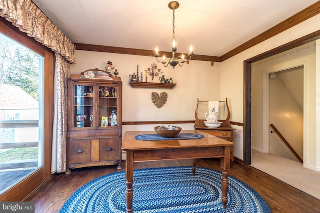 home office with a chandelier, crown molding, baseboards, and wood finished floors