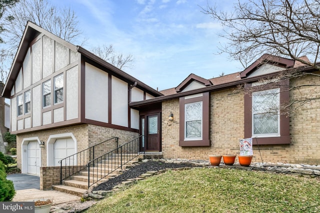 tudor home with stucco siding, driveway, brick siding, and an attached garage