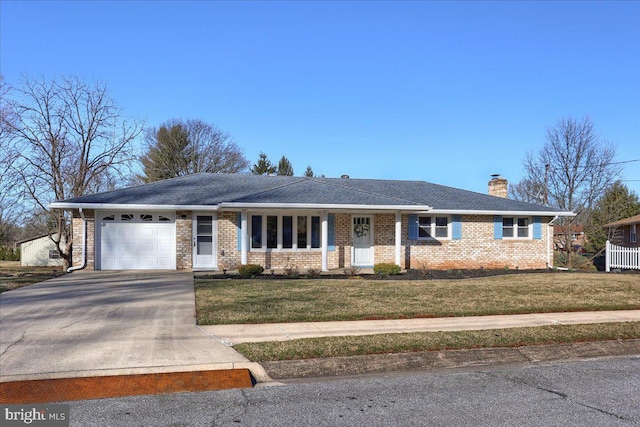 single story home with driveway, a chimney, a front lawn, a garage, and brick siding