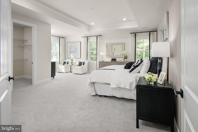 bedroom featuring baseboards, a raised ceiling, a walk in closet, carpet flooring, and recessed lighting