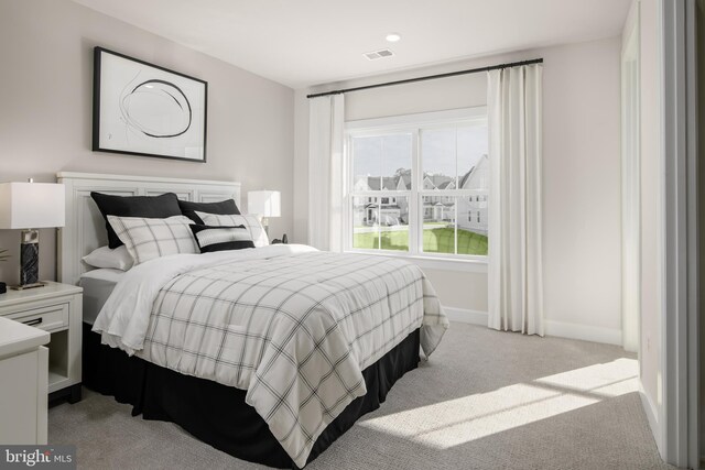 bedroom with recessed lighting, visible vents, light carpet, and baseboards