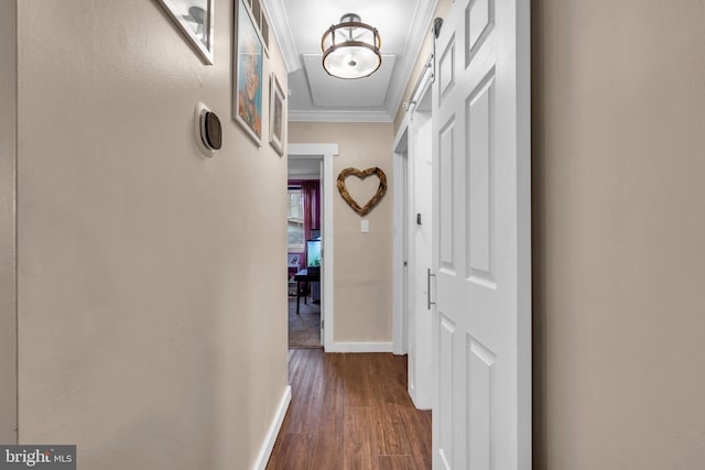 hallway featuring baseboards, dark wood-type flooring, and crown molding