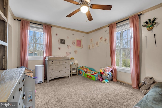 carpeted bedroom featuring ceiling fan and ornamental molding