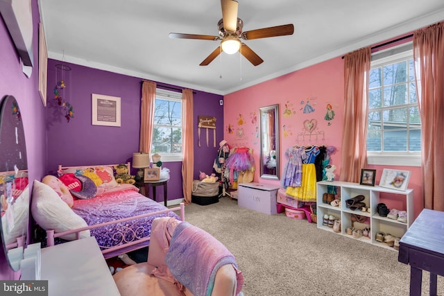 carpeted bedroom featuring ceiling fan and multiple windows