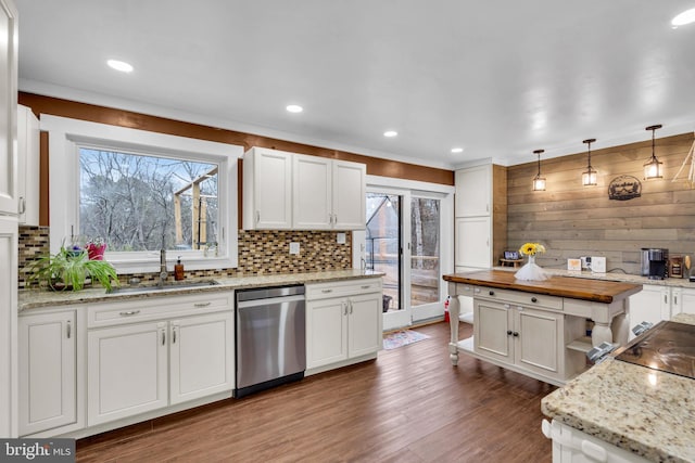 kitchen featuring white cabinetry, stainless steel dishwasher, decorative backsplash, dark wood-style floors, and decorative light fixtures