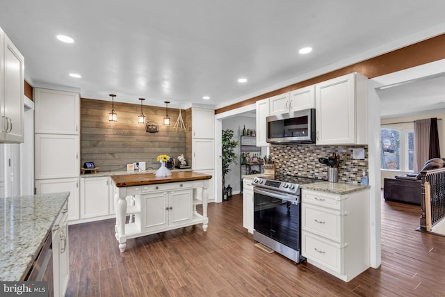 kitchen featuring appliances with stainless steel finishes, dark wood finished floors, butcher block counters, and white cabinets