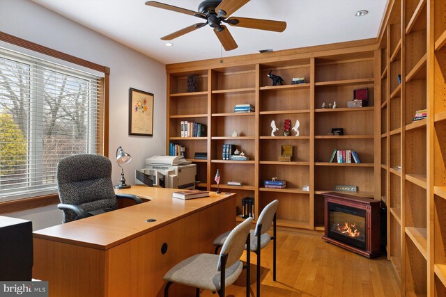 office space featuring light wood-type flooring and a ceiling fan