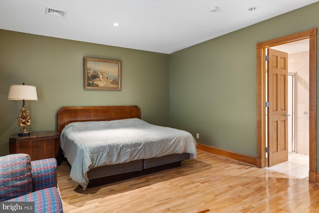 bedroom featuring baseboards, visible vents, wood finished floors, and recessed lighting