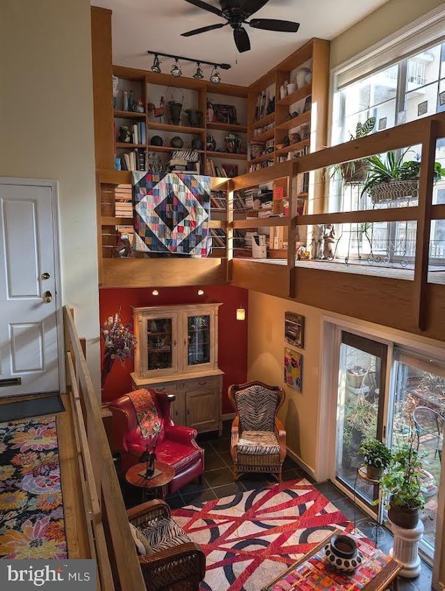 sitting room featuring track lighting, ceiling fan, and tile patterned flooring