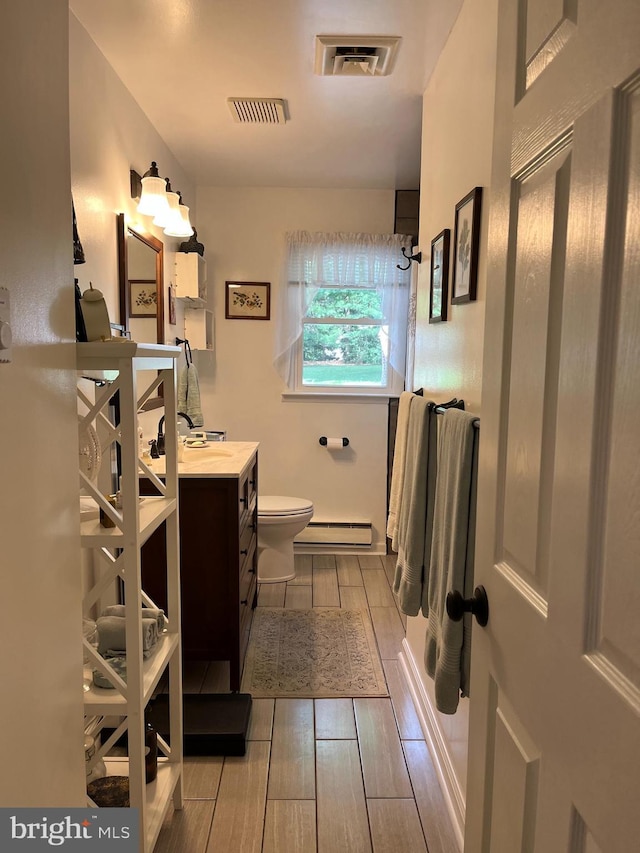 full bathroom featuring toilet, visible vents, a shower, and wood finish floors