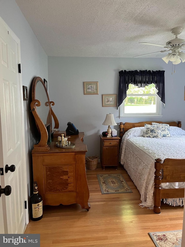 bedroom featuring a textured ceiling and wood finished floors