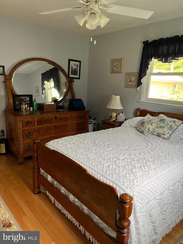 bedroom featuring a ceiling fan and wood finished floors