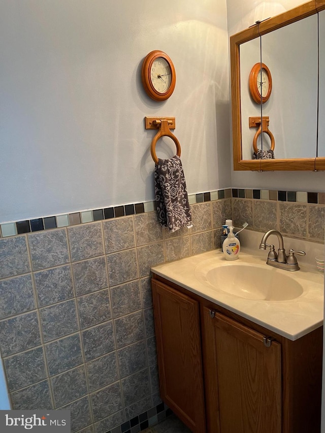 bathroom featuring tile walls and vanity