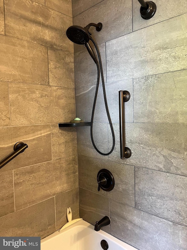 interior details featuring shower / washtub combination