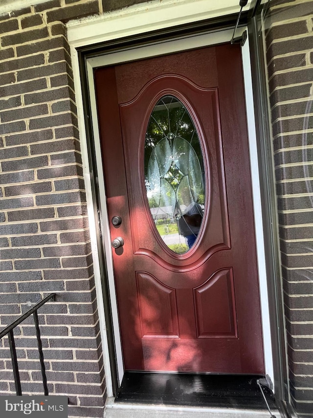 property entrance featuring brick siding