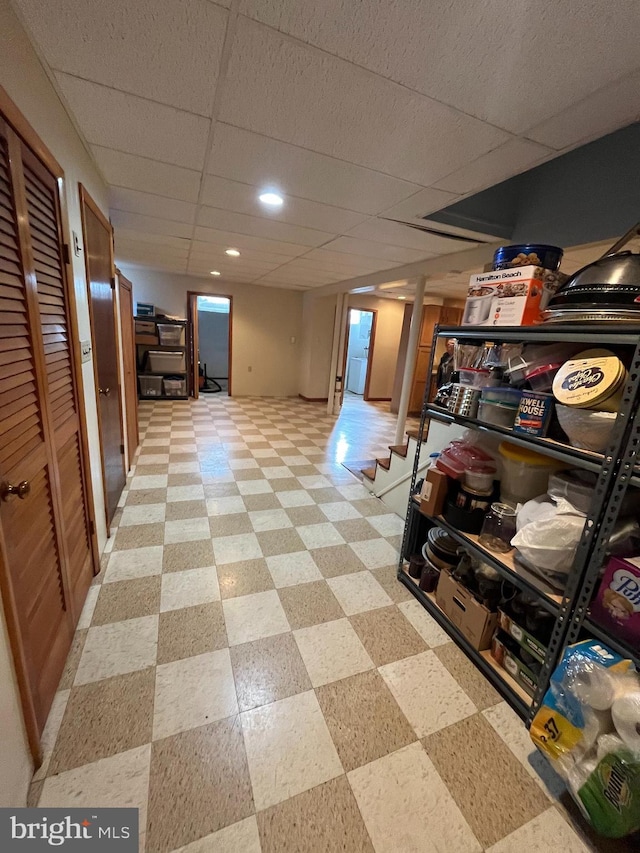 finished basement with a drop ceiling and light floors