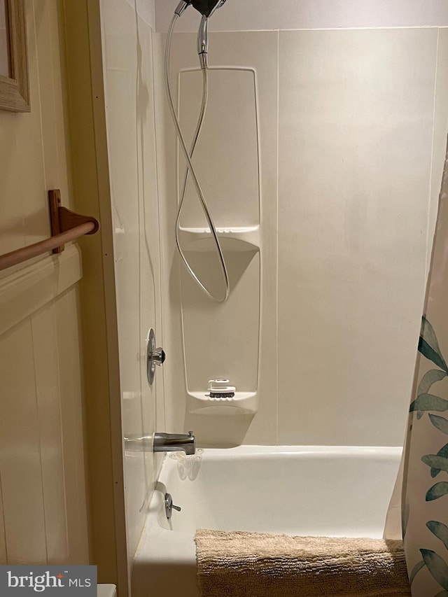 bathroom with shower / bath combo with shower curtain