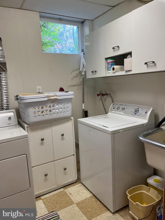 laundry area featuring washing machine and dryer and cabinet space