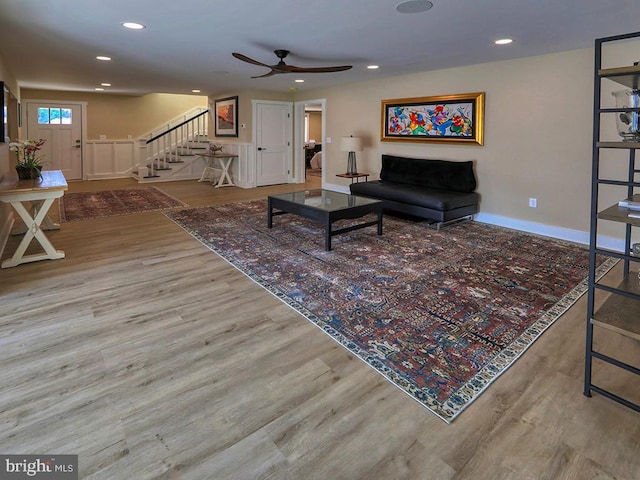 living area featuring recessed lighting, wood finished floors, and stairs