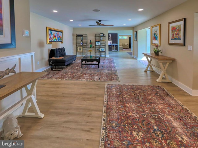 living area featuring recessed lighting, baseboards, and wood finished floors