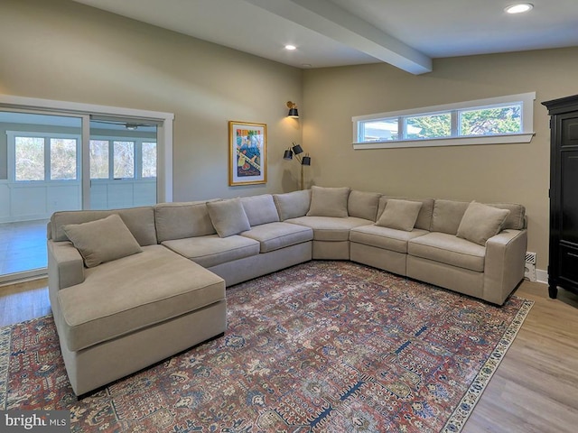 living area featuring lofted ceiling with beams, wood finished floors, and recessed lighting