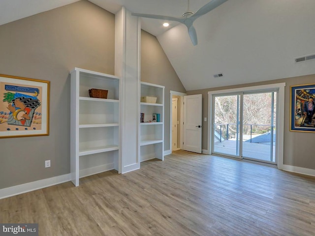 unfurnished living room with baseboards, visible vents, and wood finished floors