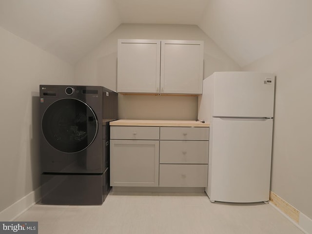 washroom featuring washer / dryer and baseboards