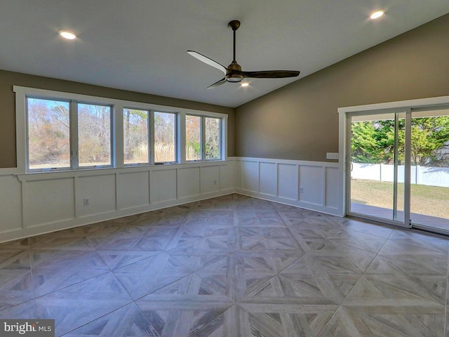 empty room with lofted ceiling, ceiling fan, recessed lighting, and a decorative wall