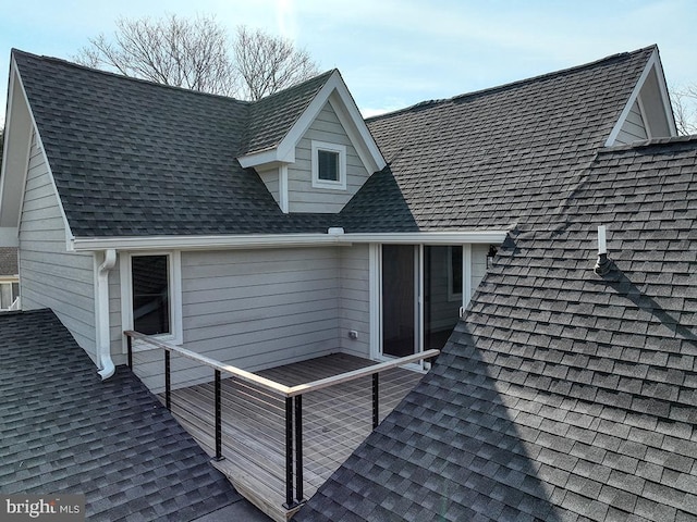 exterior space featuring a shingled roof