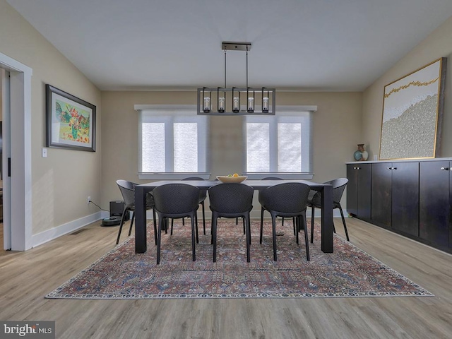 dining room featuring baseboards and wood finished floors