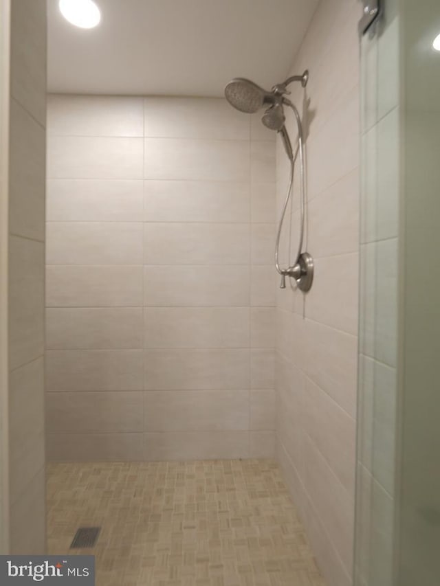 full bath featuring a stall shower and visible vents