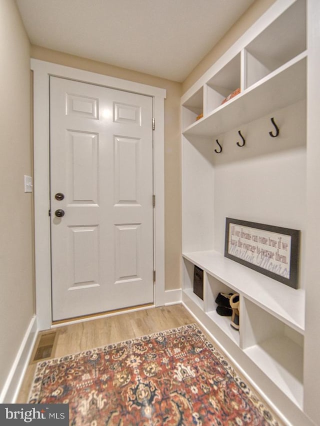 mudroom with light wood-style flooring and baseboards