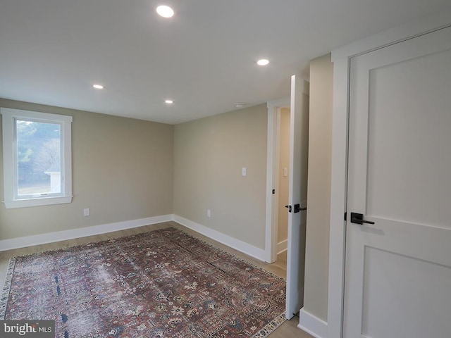 unfurnished room featuring baseboards and recessed lighting