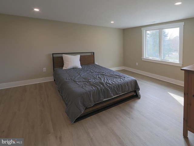 bedroom featuring recessed lighting, wood finished floors, and baseboards