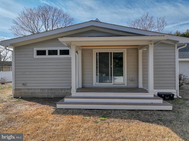 entrance to property with a lawn